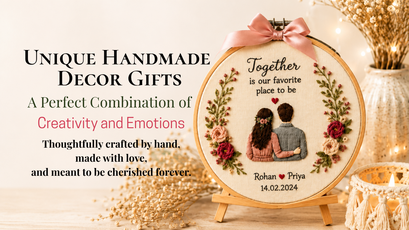 A warm and elegant blog banner showcasing unique handmade decor gifts. The image features a large personalized embroidery hoop displayed on a wooden easel, decorated with intricate floral embroidery and a three-dimensional illustration of a couple embracing from behind. The hoop includes the quote "Together is our favorite place to be" along with the names "Rohan ♥ Priya" and the date "14.02.2024." On the left side, the heading reads "Unique Handmade Decor Gifts – A Perfect Combination of Creativity and Emotions," followed by the message "Thoughtfully crafted by hand, made with love, and meant to be cherished forever." The setting is enhanced with dried flowers, a ceramic vase with soft fairy lights, and a macramé candle holder, creating a cozy and aesthetic handmade decor atmosphere.